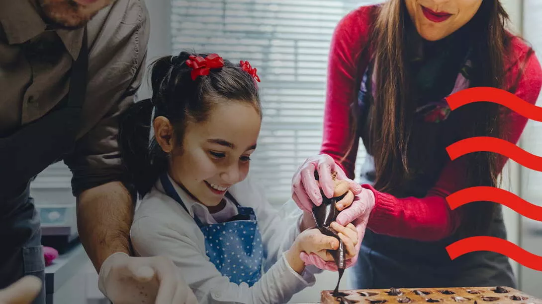 A girl baking with her parents