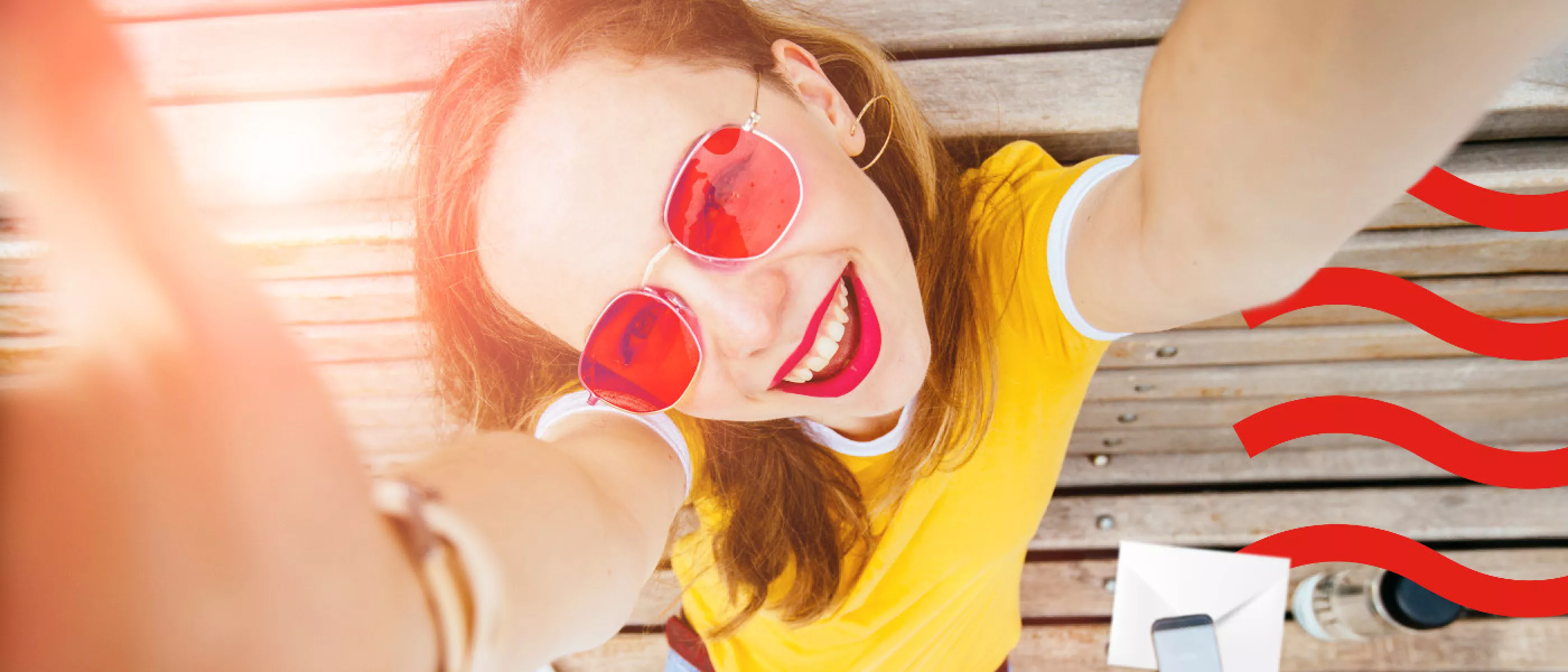 lady smiling looking up at camera in rose tinted glasses